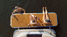 Three people relaxing on the Island Hopper Mini Mate Inflatable Boat Dock 10 x 3 ft Slim Dock Platform